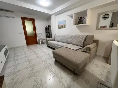 a living room with a couch and a chair at Casa adosada junto a la playa de El Perelló in Sueca