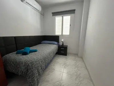 a bedroom with a bed with a blue bow on it at Casa adosada junto a la playa de El Perelló in Sueca