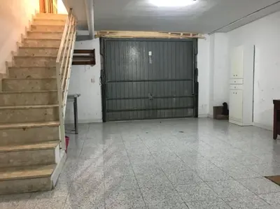 a garage with a staircase and a garage door at Casa adosada junto a la playa de El Perelló in Sueca