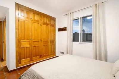 a bedroom with a white bed and a window at Holiday Home Valencia in Riba-Roja De Turia
