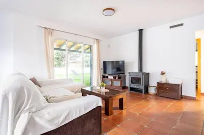 a living room with a couch and a tv at Holiday Home Valencia in Riba-Roja De Turia