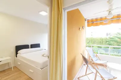 a bedroom with a bed and a window at Global Vacacional, Apartamento con piscina y terraza en Canet in Canet de Berenguer