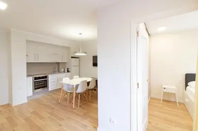 a kitchen and dining room with a table and chairs at Global Vacacional, Apartamento con piscina y terraza en Canet in Canet de Berenguer