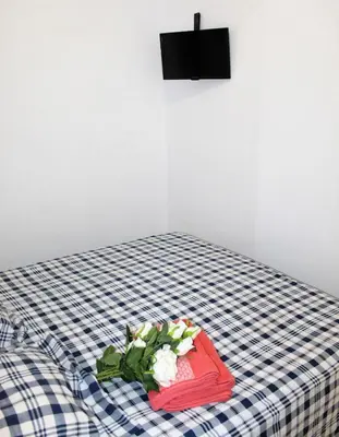 a bed with a red tray with flowers on it at Piso Cerca Universidades y de la Playa in Valencia