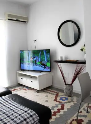 a living room with a flat screen tv on a white cabinet at Piso Cerca Universidades y de la Playa in Valencia