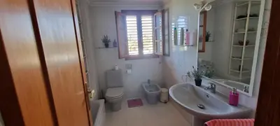 a bathroom with a sink and a toilet and a mirror at Casa en la playa in Sagunto