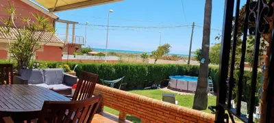 a view of a patio with a table and chairs at Casa en la playa in Sagunto
