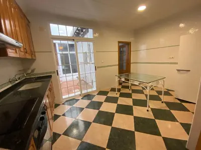 a kitchen with a ping pong table on a checkered floor at MAR i MONTAÑA en Cullera Villa Juani in Cullera