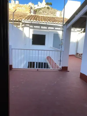 a balcony of a white building with a gate at MAR i MONTAÑA en Cullera Villa Juani in Cullera