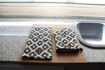 two ties sitting on a cutting board next to a sink at Precioso apartamento con vistas al mar. Piscina. in Valencia
