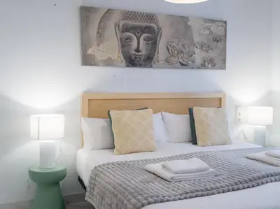 a bedroom with a large bed with two lamps at Central Market - Ciutat Vella, exclusively for families - Mid-term in Valencia