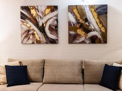 three pieces of art on a wall above a couch at Central Market - Ciutat Vella, exclusively for families - Mid-term in Valencia