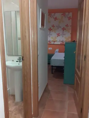 a bathroom with a sink and a toilet and a mirror at Amanecer marino, solo a 5 minutos andando de la playa in Puzol