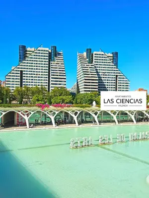 a bridge over a river with buildings in the background at Apartamentos Las Ciencias O in Valencia