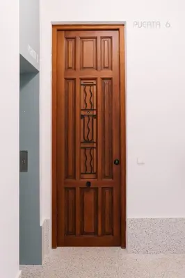 a wooden door in a hallway at La Alfarería in Valencia