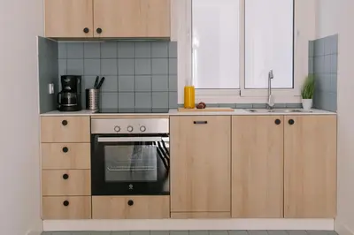 a kitchen with wooden cabinets and an oven at La Alfarería in Valencia