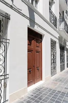 a wooden door on the side of a building at La Alfarería in Valencia