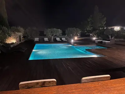 a swimming pool at night with lights at La Traviesa,Villa de Lujo de 500 m. en el Campo con Piscina in Campo Arcís