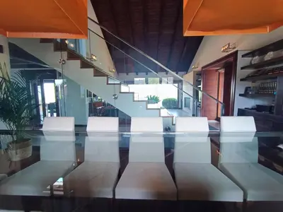 a lobby with white chairs and a staircase at La Traviesa,Villa de Lujo de 500 m. en el Campo con Piscina in Campo Arcís