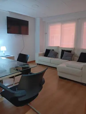 a living room with a couch and a table at Alojamiento Temporal para Familias, Turismo, Estudiantes y Trabajo 