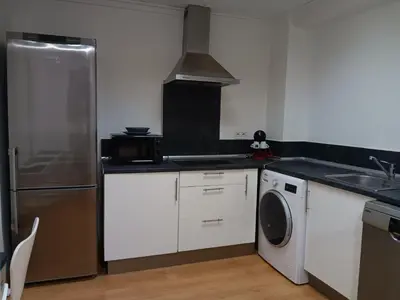 a kitchen with a stainless steel refrigerator and a dishwasher at Alojamiento Temporal para Familias, Turismo, Estudiantes y Trabajo 