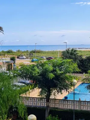 a view of the beach from the balcony of a resort at Bonito apartamento con vistas al mar in Playa Pobla de Farnals
