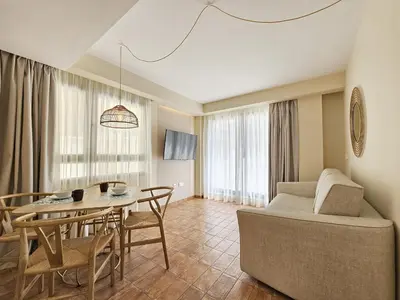 a living room with a table and a couch at Apartamentos Las Ciencias R in Valencia