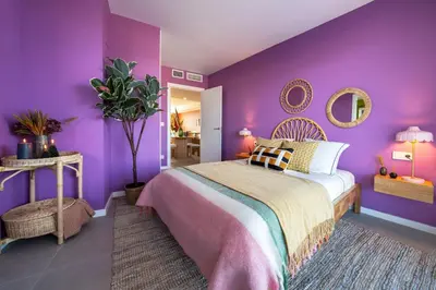 a purple bedroom with a bed and a purple wall at Gran Canet 2BR! Walk to Beach, Sea View, Sauna & Gym in Canet de Berenguer