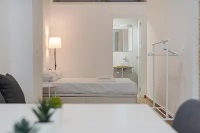 a hotel room with a bed and a mirror at VLC HOST- Fray Pedro in Valencia
