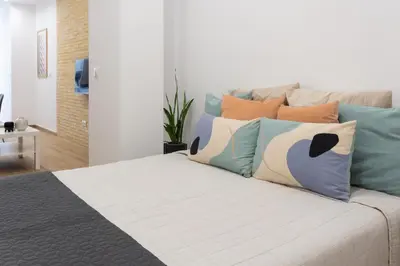 a bedroom with a bed with pillows on it at VLC HOST- Fray Pedro in Valencia