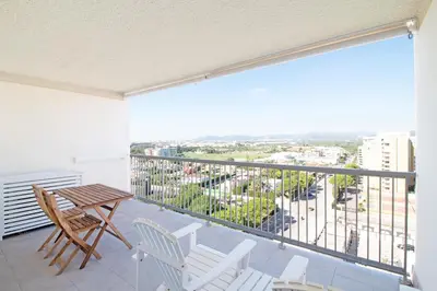 a balcony with a table and chairs and a view at Global Vacacional, Moderno apartamento con piscina en la playa de Canet in Canet de Berenguer