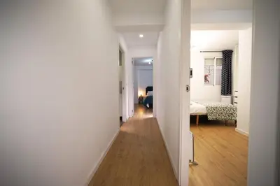 a hallway with a bedroom and a bed in a room at Casa Ross en Ruzafa in Valencia