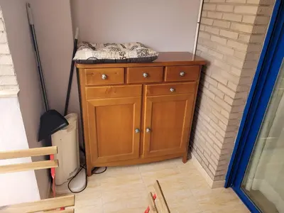 a bedroom with a wooden dresser with a bed on it at Apartamento en el Grau de Moncofa entre 2 y 3 linea de playa in Moncófar