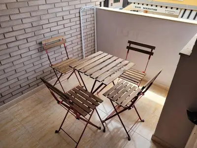 two chairs and a table and a table and two chairs at Apartamento en el Grau de Moncofa entre 2 y 3 linea de playa in Moncófar