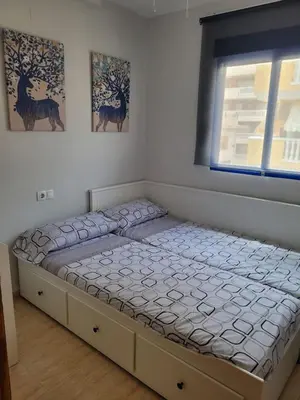 a large bed in a room with a window at Apartamento en el Grau de Moncofa entre 2 y 3 linea de playa in Moncófar