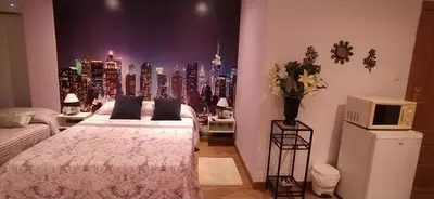 a bedroom with a view of a city skyline at Hostal Happystay in Valencia