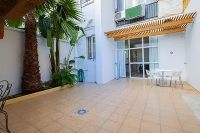 a patio with a table and chairs in a building at FLORIT FLATS - The Vella Apartment in Valencia