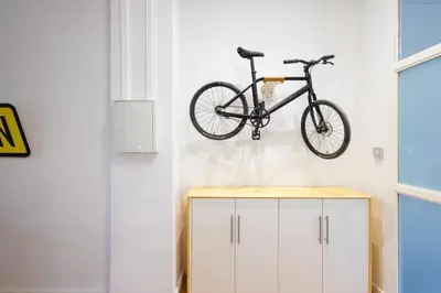 a bike hanging on a wall in a room at FLORIT FLATS - The Vella Apartment in Valencia