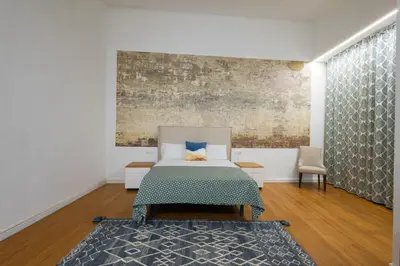 a bedroom with a bed and a painting on the wall at FLORIT FLATS - The Vella Apartment in Valencia
