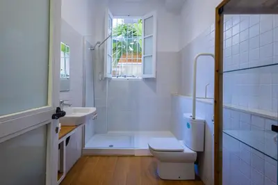 a bathroom with a toilet and a sink and a shower at FLORIT FLATS - The Vella Apartment in Valencia