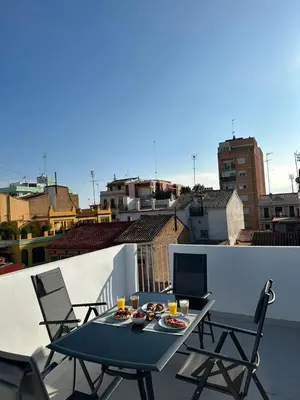 a table and chairs on a balcony with a view of a city at Barraca Beach in Valencia