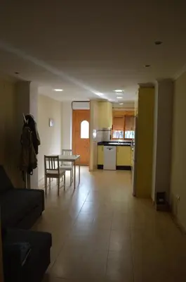 a living room with a table and a kitchen at Barraca Beach in Valencia