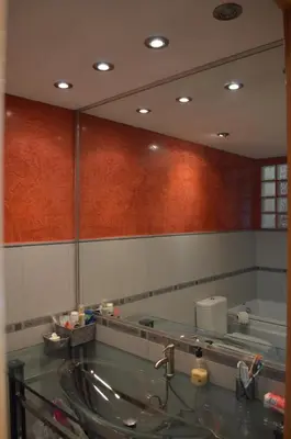a bathroom with a large mirror and a sink at Barraca Beach in Valencia