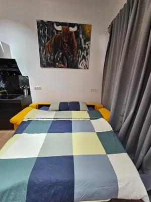 a bedroom with a bed with a cow on the wall at Bear Homes - Olimpia Suite in Valencia