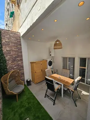 a patio with a table and chairs and a kitchen at Bear Homes - Olimpia Suite in Valencia