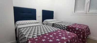two twin beds in a room with stars at Precioso apartamento de diseño para 4-6 personas VT-55212-V in Valencia