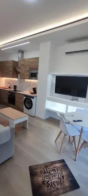 a living room with a table and a kitchen at Precioso apartamento de diseño para 4-6 personas VT-55212-V in Valencia