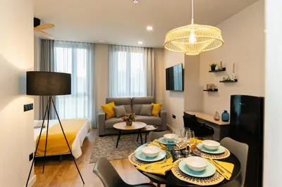 a living room with a dining table and a couch at Dorm4You Arena 2 in Valencia