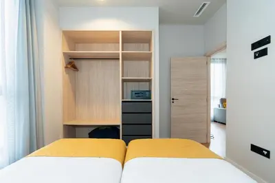 a small bedroom with two beds and a closet at Dorm4You Arena 2 in Valencia