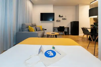 a hotel room with a bed and a living room at Dorm4You Arena 2 in Valencia